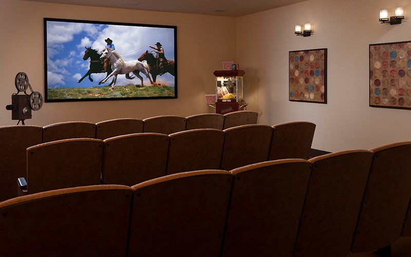 Spacious theatre room with large tv and reclining seats